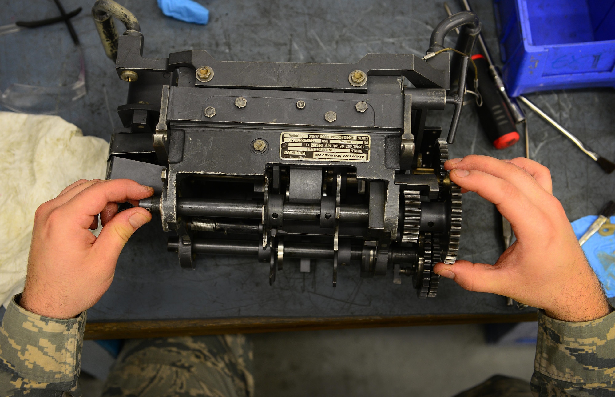 U.S. Air Force Senior Airman Derek Thayer, 31st Munitions Squadron armament technician, inspects an F-16 Fighting Falcon’s ammunition conveyor interface unit, May 20, 2015, at Aviano Air Base, Italy. The interface unit grabs bullets from an ammunition drum and loads them into a gun barrel. (U.S. Air Force photo by Senior Airman Matthew Lotz/Released)