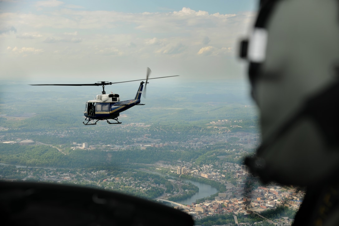 1st Lt. Brittny Barney, 1st Helicopter Squadron special missions pilot, checks the distance of a UH-1N Twin Huey at Camp Dawson, W.Va., May 15, 2015. Helicopter pilots have the responsibility of safely conducting flight operations, including: planning, briefing, flying, mission management and debriefing. (U.S. Air Force photo/ Airman 1st Class J.D. Maidens)