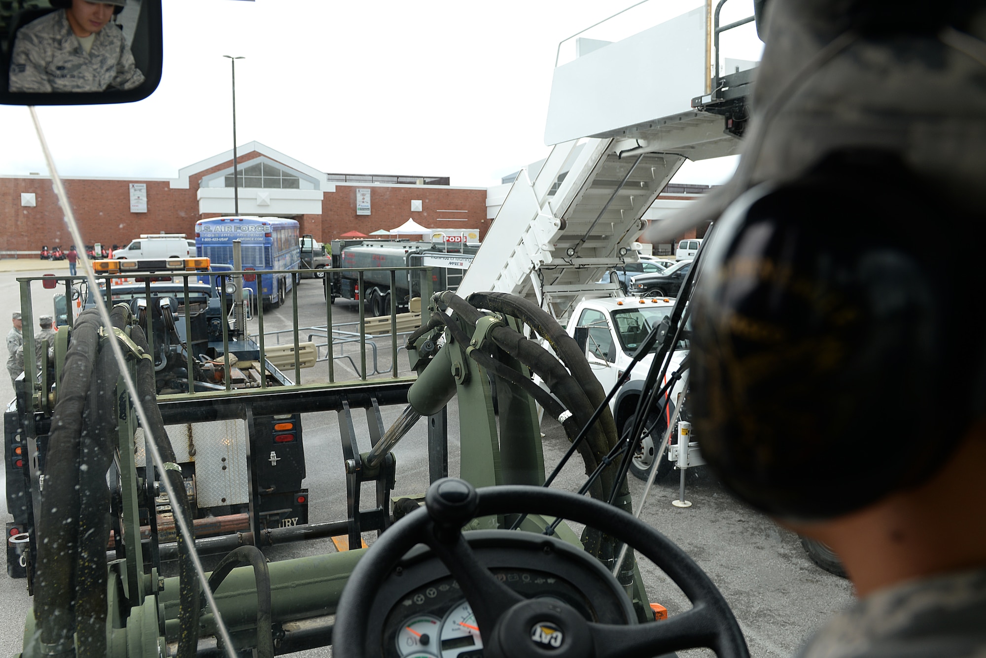 Senior Airman Jeffery Severn, 375 Logistics Readiness Squadron Vehicle Operation and Dispatch, shows observers the controls and functions of a 10K All Terrain Forklift during National Defense Transportation Week May 11, 2015 at Scott Air Force Base, Illinois. Severn and other members of LRS gave demonstrations and shared experiences with base members about the different vehicles they utilize in their career field. (U.S. Air Force photo/Senior Airman Joshua Eikren)