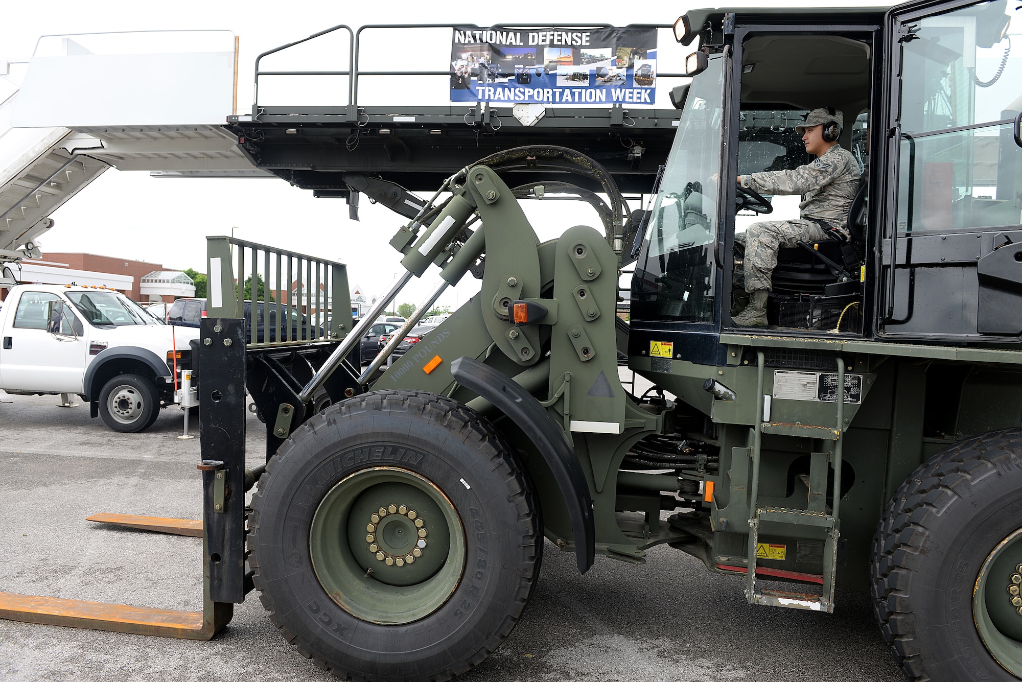 Senior Airman Jeffery Severn, 375 Logistics Readiness Squadron Vehicle Operation and Dispatch, shows observers the controls and functions of a 10K All Terrain Forklift during National Defense Transportation Week May 11, 2015 at Scott Air Force Base, Illinois. Severn and other members of LRS gave demonstrations and shared experiences with base members about the different vehicles they utilize in their career field. (U.S. Air Force photo/Senior Airman Joshua Eikren)