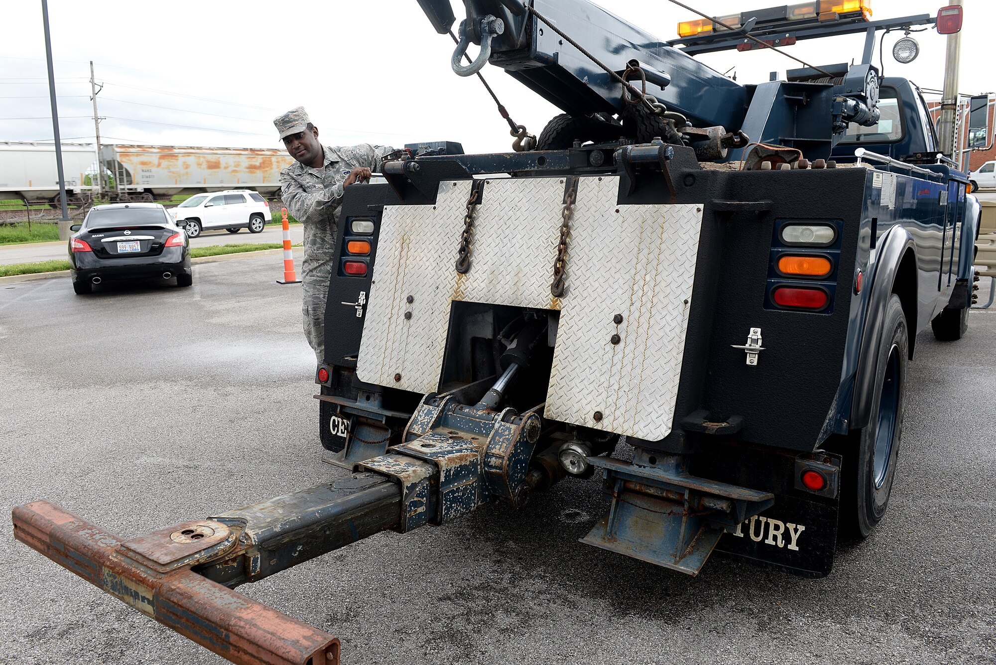 Airman First Class Marcus Johnson, 375 Logistics Readiness Squadron Vehicle Operation and Dispatch, demonstrates how to use the wheel lift assembly on a Tow Truck May 11, 2015 at Scott Air Force Base, Illinois. The 375 LRS set up static displays in the Base Exchange parking lot to show the vehicles they use to complete the mission. (U.S. Air Force photo/Senior Airman Joshua Eikren)