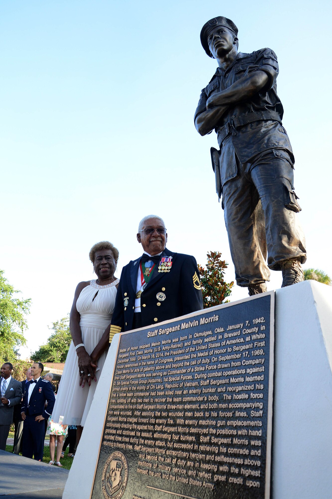 U.S. Army Sgt. 1st Class Melvin Morris, Medal of Honor recipient, his wife, Mary, stand next to a live-size bronze statue of himself; standing arms crossed, in his 1960's era Army fatigues during a ceremony, which included an unveiling, May 14, 2015, at Riverfront Park in Cocoa, Fla. The President, in the name of Congress, has awarded more than 3,400 Medals of Honor to our nation's bravest Soldiers, Sailors, Airmen, Marines, and Coast Guardsmen since the decoration's creation in 1861. (Photo courtesy/Florida Today)