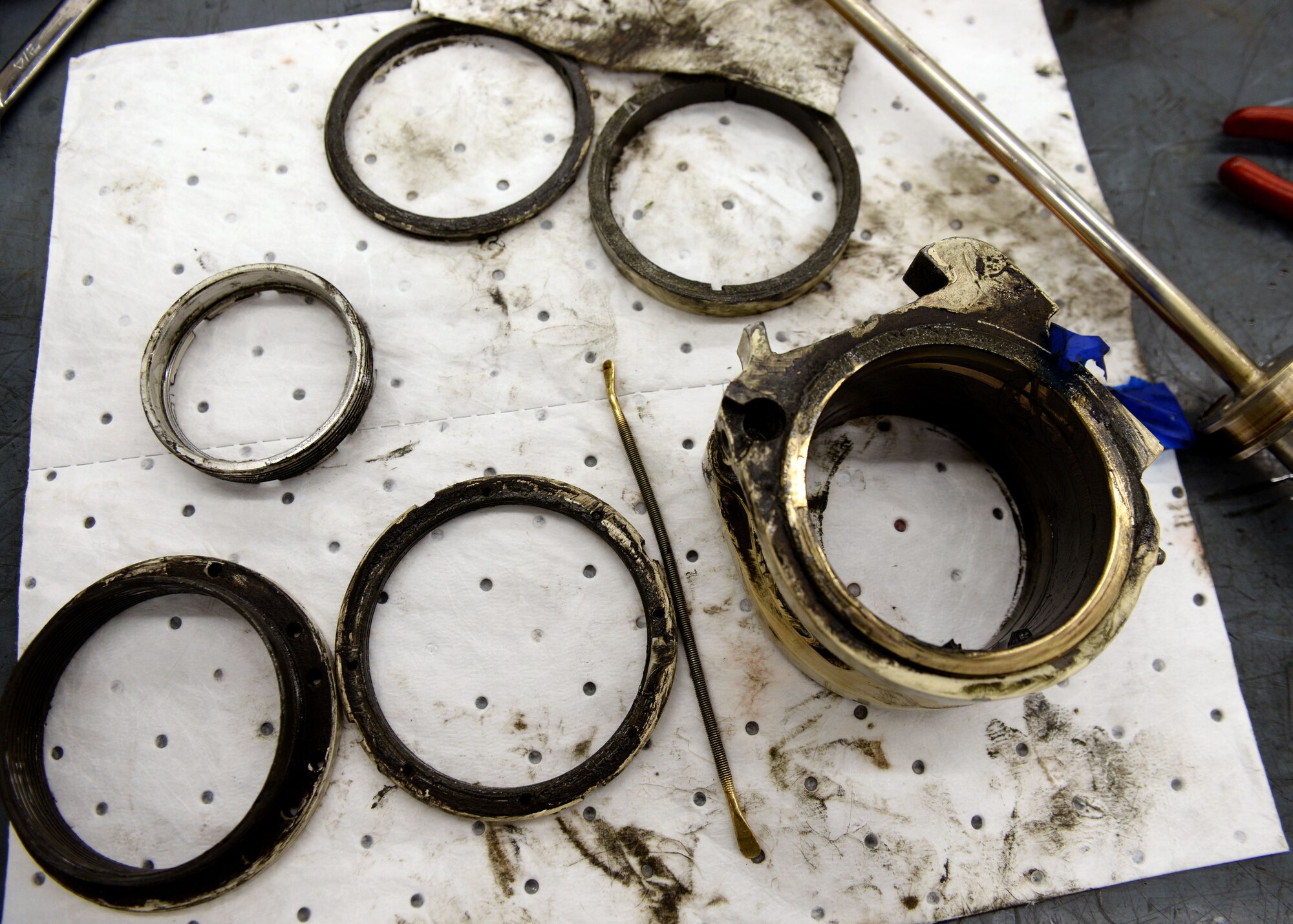 Upper and lower bearings of landing gear sit on absorbent cloth before a specialized washer cleans them, May 18, 2015, at Aviano Air Base, Italy.  The bearings are inspected after being washed for further damage. Each part must be removed in sequence, washed and inspected to ensure the landing gear’s integrity.  (U.S. Air Force photo by Airman 1st Class Cary Smith/Released)