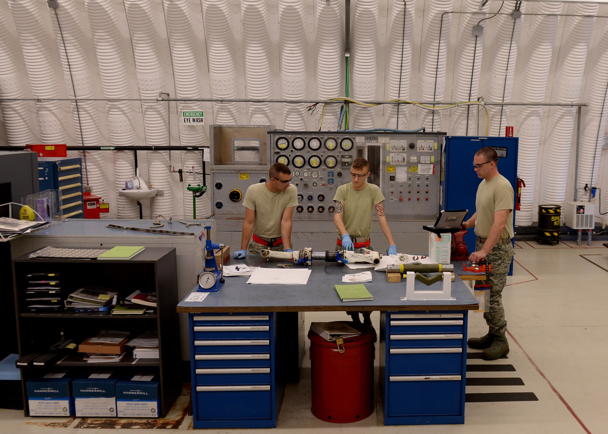 U.S. Airmen with the 31st Maintenance Squadron hydraulic section prepare to disassemble a landing gear, May 18, 2015, at Aviano Air Base, Italy.  Each part must be removed in sequence, washed and inspected to ensure the landing gear’s integrity.  (U.S. Air Force photo by Airman 1st Class Cary Smith/Released)