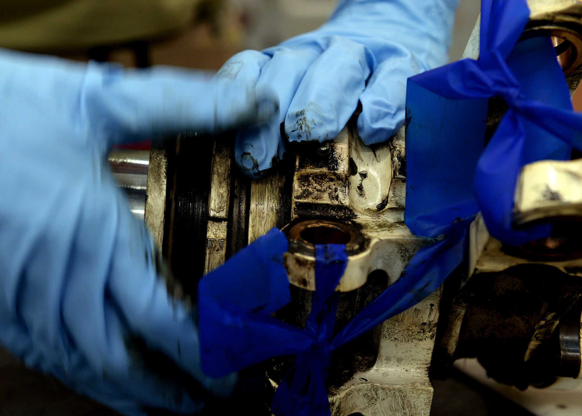 U.S. Airmen from the 31st Maintenance Squadron hydraulic section separate two main parts of a landing gear strut, May 18, 2015, at Aviano Air Base, Italy.  Each part must be removed in sequence, washed and inspected to ensure the strut’s integrity. (U.S. Air Force photo by Airman 1st Class Cary Smith/Released)