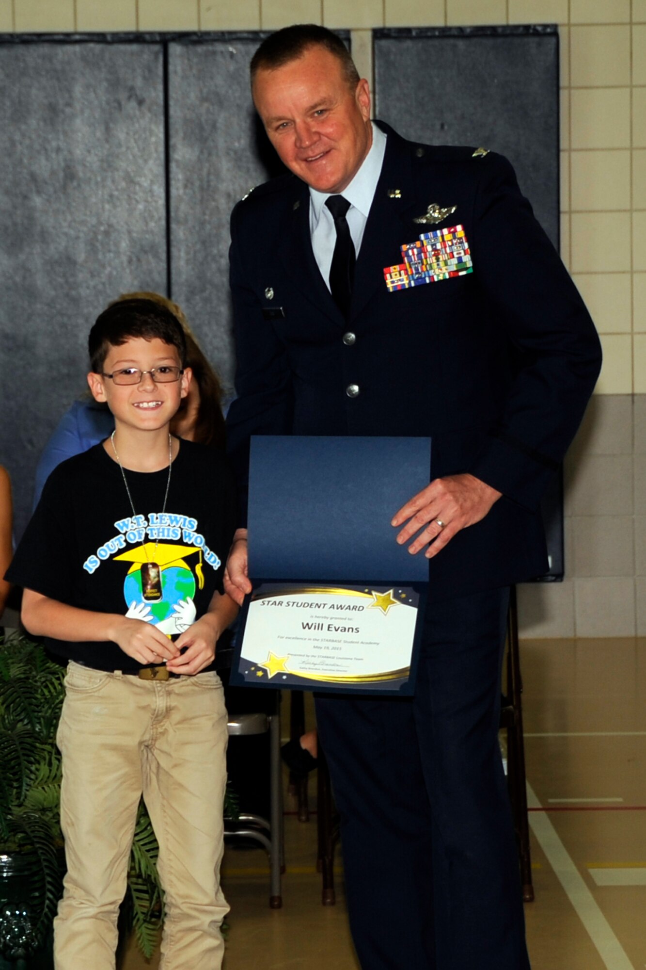 Will Evans, a student at W.T. Lewis Elementary School in Bossier City, La., receives a Star Student Award from U.S. Air Force Reserve Col Bruce Cox, Commander of the 307th Bomb Wing during the graduation of the 900th STARBASE Class on May 19, 2015. Will took part in 25 hours of hands-on minds-on STEM (science, technology, engineering, and mathematics) curriculum. Some of the topics he experienced were Newton’s laws of Forces and Motion, Properties of Matter, and the difference in Chemical and Physical changes. (U.S. Air Force photo by Master Sgt. Laura Siebert/Released)
