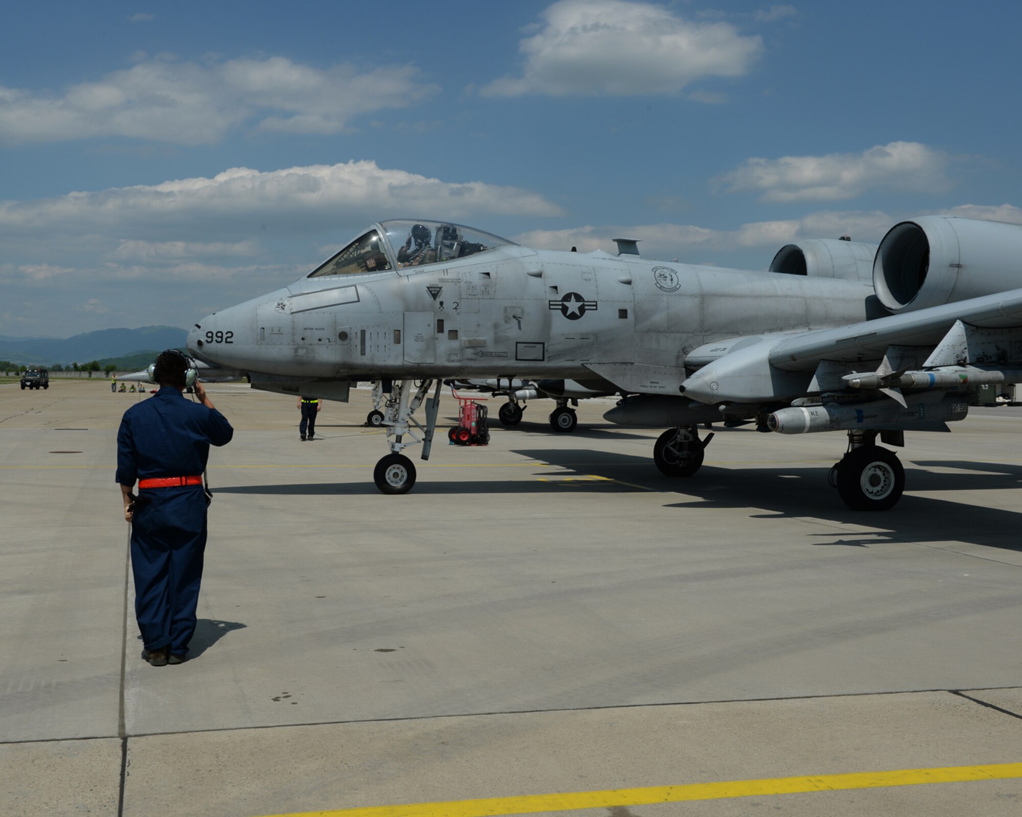 A U.S. Air Force crew chief assigned to the 354th Expeditionary Fighter Squadron salutes the pilot of an A-10 Thunderbolt II aircraft during a theater security package deployment at Sliac Air Base, Slovakia, May 19, 2015. As part of the deployment, the U.S. and Slovakia air forces will train together May 18-22 to improve interoperability in allied air operations and multinational close-air-support operations. (U.S. Air Force photo by Senior Airman Dylan Nuckolls/Released)