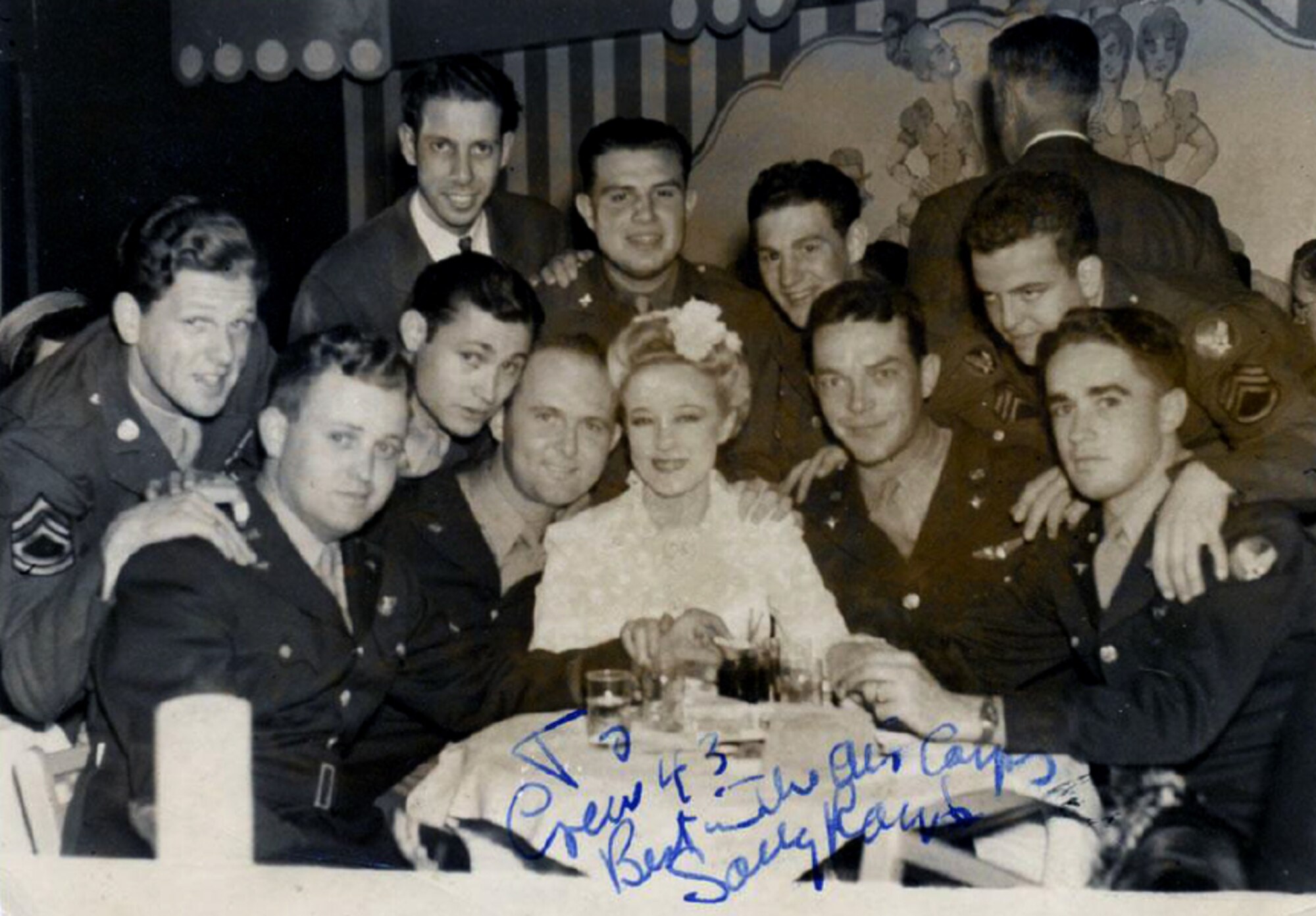 U.S. Army Air Forces 2nd Lt. Harold Russell, third from the right, poses for a photo with his fellow aircrew members, and Sally Rand, a famous dancer, April 30, 1943. The ten crew members survived and aircraft crash in Arkel, Netherlands, during World War II. (Courtesy photo)