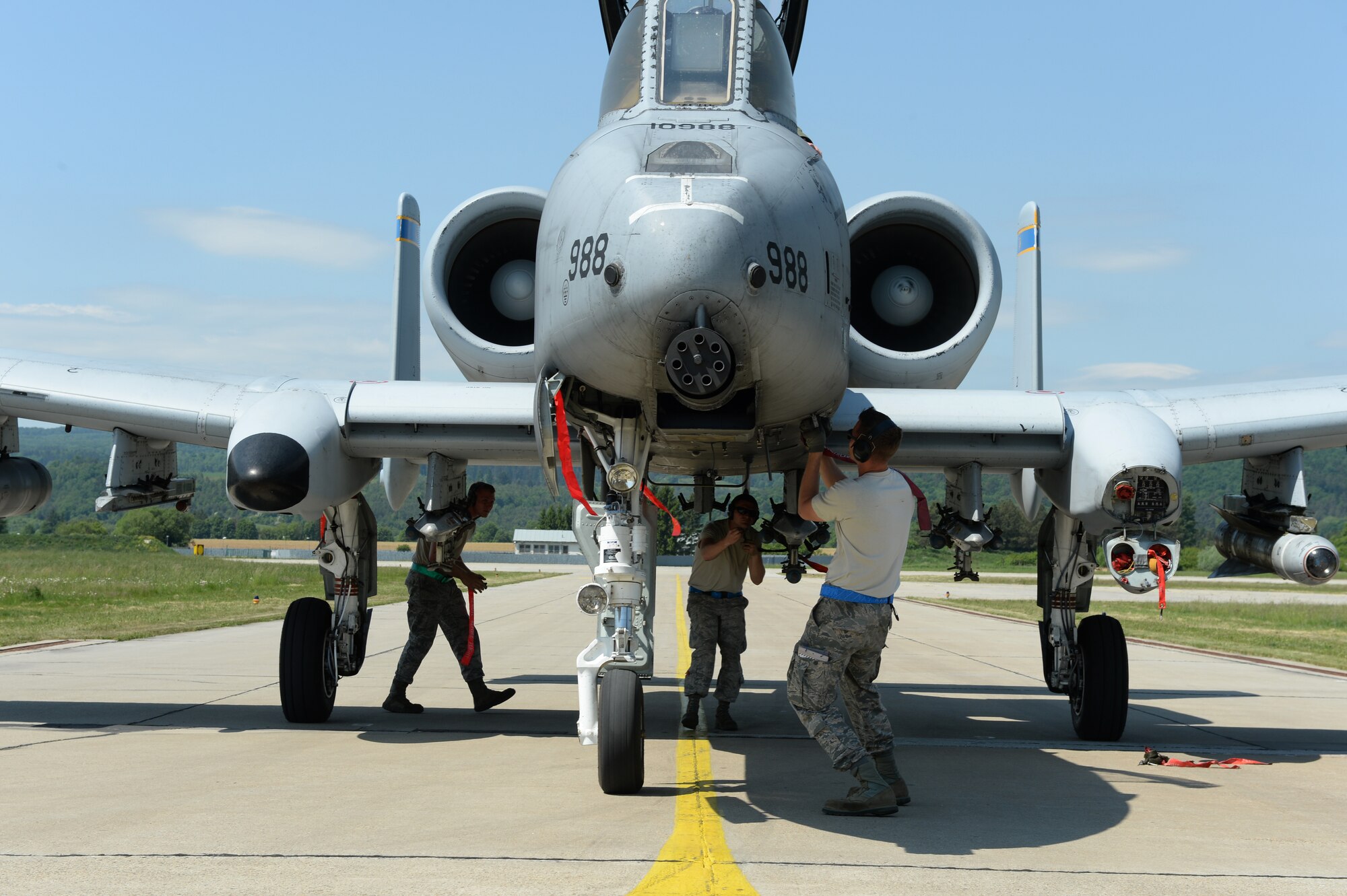 Three U.S. Air Force Airmen perform an end of runway inspection on an A-10 Thunderbolt II aircraft assigned to the 354th Expeditionary Fighter Squadron during a theater security package deployment at Sliac Air Base, Slovakia, May 19, 2015. More than 40 Airmen from the 354th EFS deployed to Slovakia to participate in a theater security package in support of Operation Atlantic Resolve. (U.S. Air Force photo by Senior Airman Dylan Nuckolls/Released)