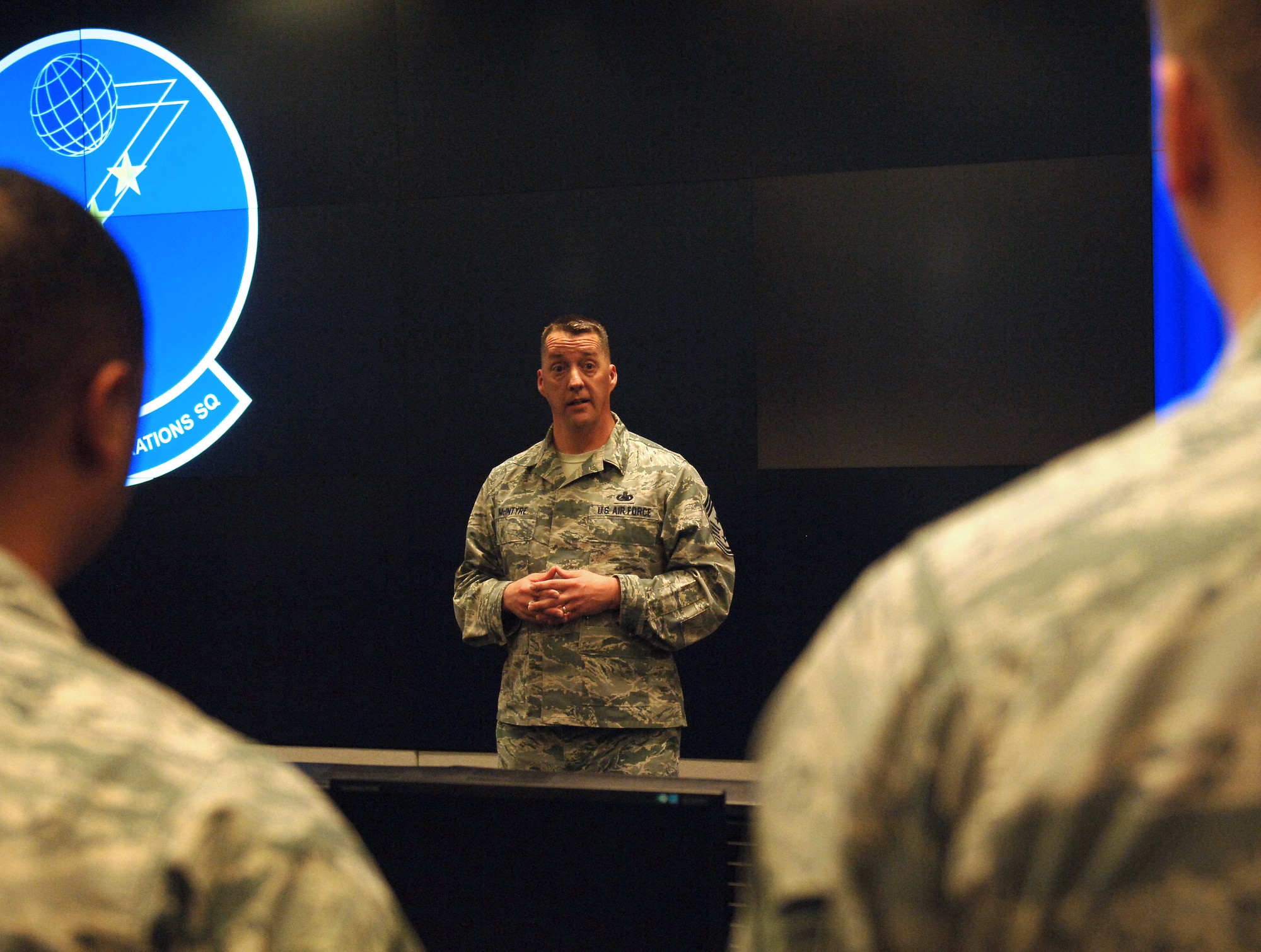 U.S. Air Force Chief Master Sgt. Douglas McIntyre, Air Force Space Command command chief, speaks to Airmen of the 83rd Network Operations Squadron during an all call at Langley Air Force Base, Va., May 15, 2015. McIntyre visited the mission partner units to discuss the importance of job performance and knowledge with the Airmen assigned. (U.S. Air Force photo by Staff Sgt. Teresa J. Cleveland/Released)