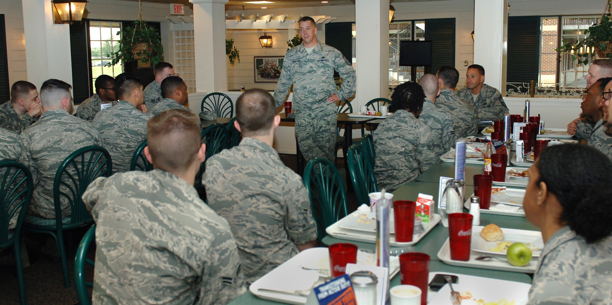 U.S. Air Force Chief Master Sgt. Douglas McIntyre, Air Force Space Command command chief, eats breakfast and speaks with Airmen from the 83rd Network Operations Squadron at Langley Air Force Base, Va., May 15, 2015. During his visit, McIntyre also had lunch with noncommissioned officers and spoke to the Airmen about being “World Champions.” (U.S. Air Force photo by Staff Sgt. Teresa J. Cleveland/Released)