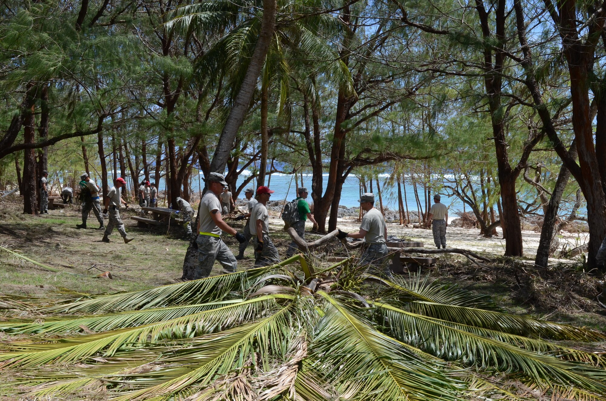 Airmen from squadrons across the base move a pile of debris during base clean-up May 21, 2015 at Tarague Beach, Guam. Airmen, Soldiers, Sailors and civilians participated in the clean-up to recover from Typhoon Dolphin, which hit the island May 16. (U.S. Air Force photo by Airman 1st Class Alexa Ann Henderson/Released)