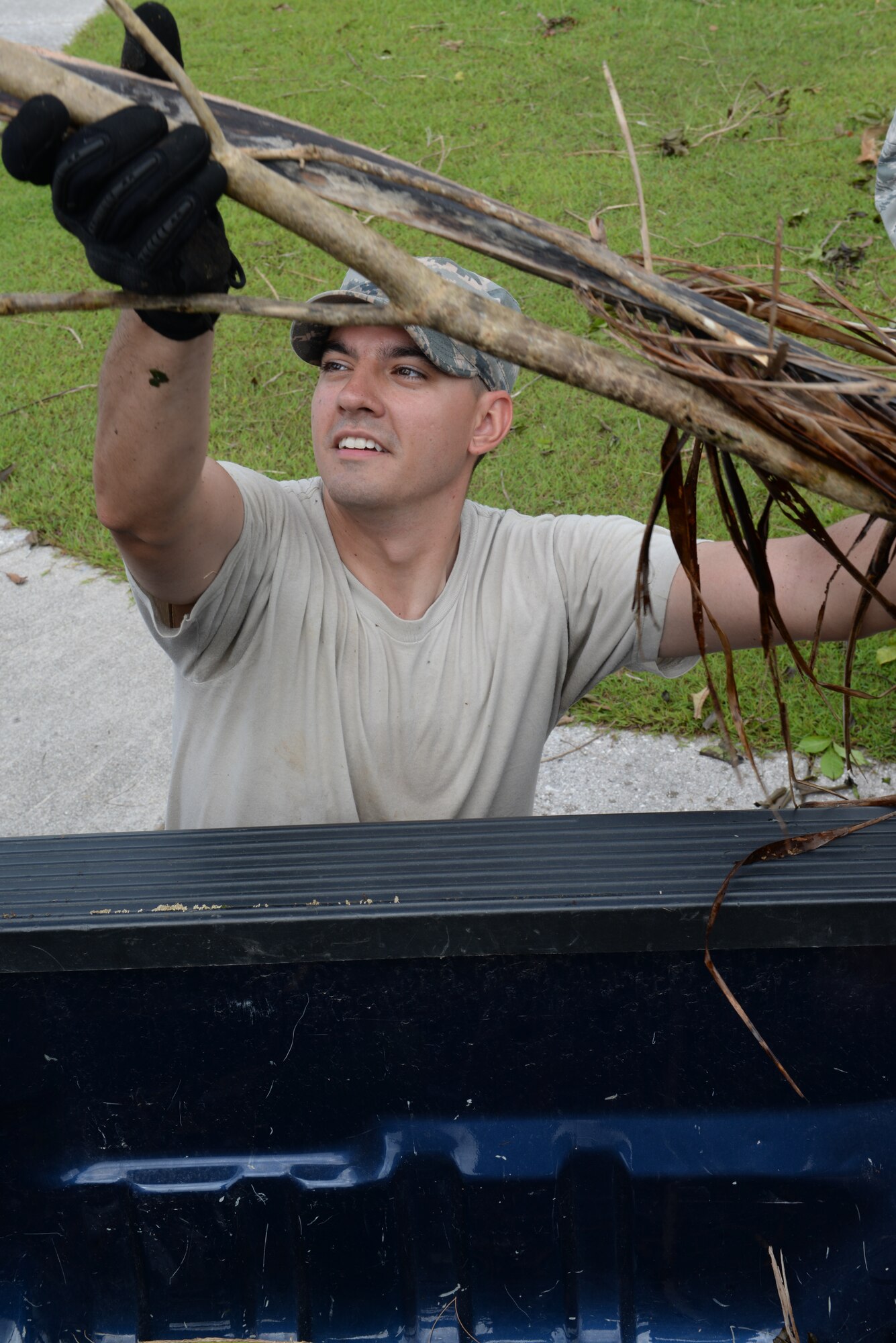 Staff Sgt. Matthew McClellon, 644th Combat Communications Squadron client systems technician, loads debris into a truck bed during the week long clean-up efforts May 20, 2015, at Andersen Air Force Base, Guam. Andersen personnel including 36th Wing Airmen, Guam National Guard and Reserves, and Andersen Army and Navy tenant units participated in clean-up efforts to recover from Typhoon Dolphin, which hit the island May 16. (U.S. Air Force photo by Senior Airman Amanda Morris/Released)