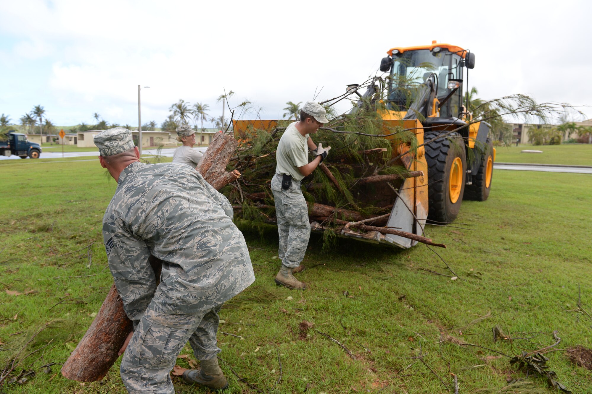 Airmen from the 36th Civil Engineer Squadron remove debris left in the wake of Typhoon Dolphin, May 19, 2015, at Andersen Air Force Base, Guam. Andersen personnel including 36th Wing Airmen, Guam National Guard and Reserves, and Andersen Army and Navy tenant units participated in the week long clean-up efforts to recover from Typhoon Dolphin, which hit the island May 16. (U.S. Air Force photo by Airman 1st Class Joshua Smoot