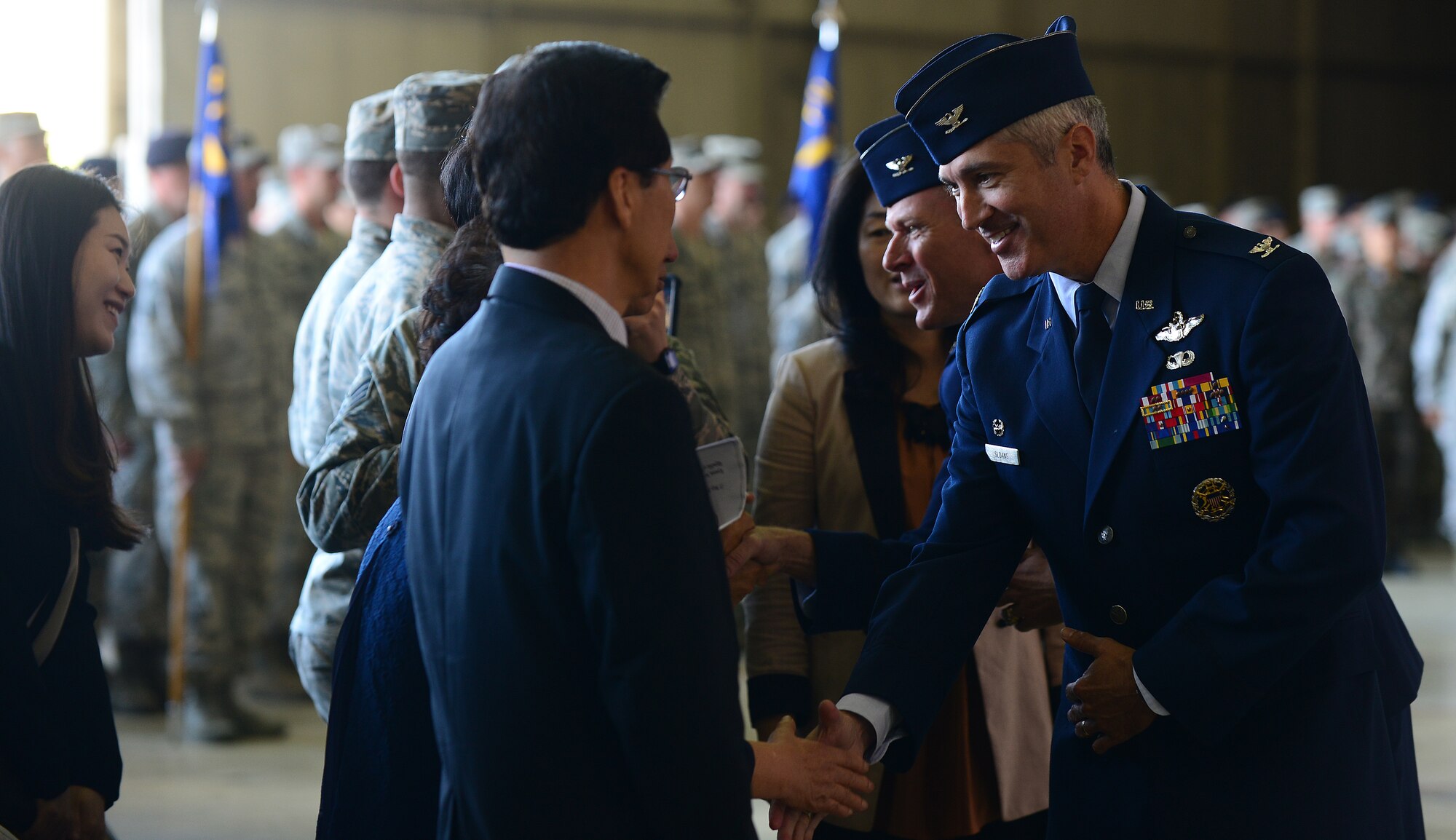 Col. Jeremy “Wolf” Sloane, 8th Fighter Wing commander (right), and Col. Ken Ekman, 8th FW outgoing commander, exchange greetings with South Korean civic leaders after the 8th FW change of command ceremony at Kunsan Air Base, Republic of Korea, May 21, 2015. Sloane has served in the Air Force for 23 years and has more than 2,500 flying hours in the F-16 Fighting Falcon, T-37 Tweet and T-38 Talon, including 235 combat hours in Operations Northern Watch, Southern Watch, Joint Guard and Allied Force. (U.S. Air Force photo by Staff Sgt. Nick Wilson/Released) 