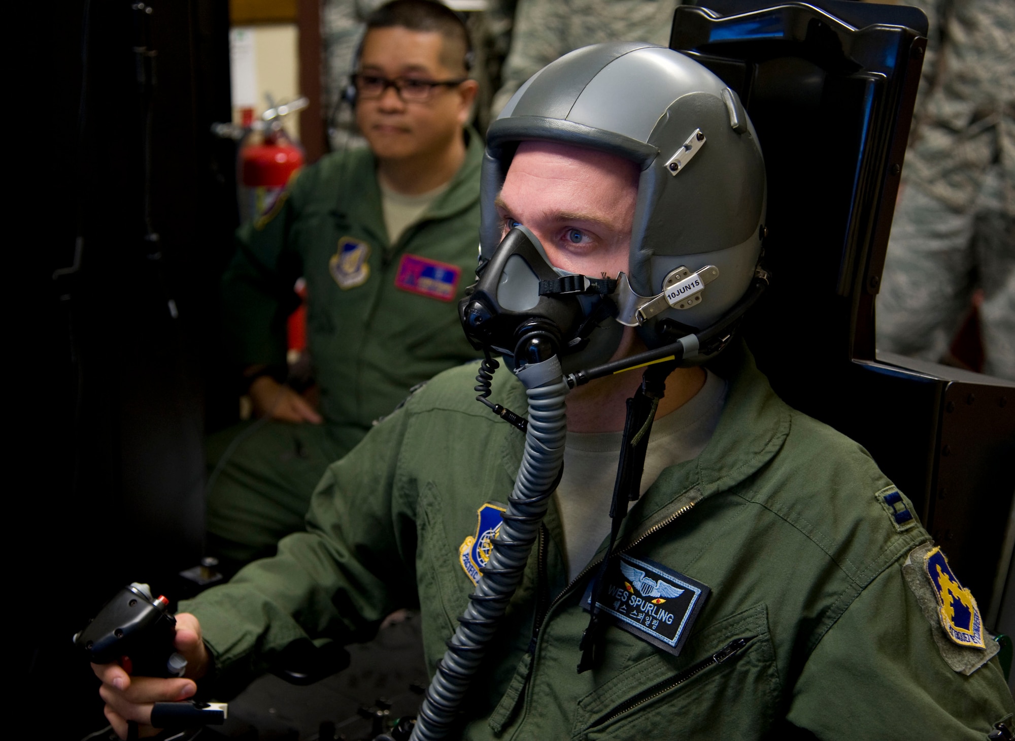 U.S. Air Force Capt. Wes Spurling, 8th Operations Support Squadron operations flight commander assigned to Kunsan Air Base, Republic of Korea, simulates flying in a hypoxia familiarization trainer at Misawa AB, Japan, May 20, 2015. Pilots are required to participate in this training to understand how their bodies react to a deficient amount of oxygen reaching their body, called hypoxia. (U.S. Air Force photo by Airman 1st Class Jordyn Fetter/Released)