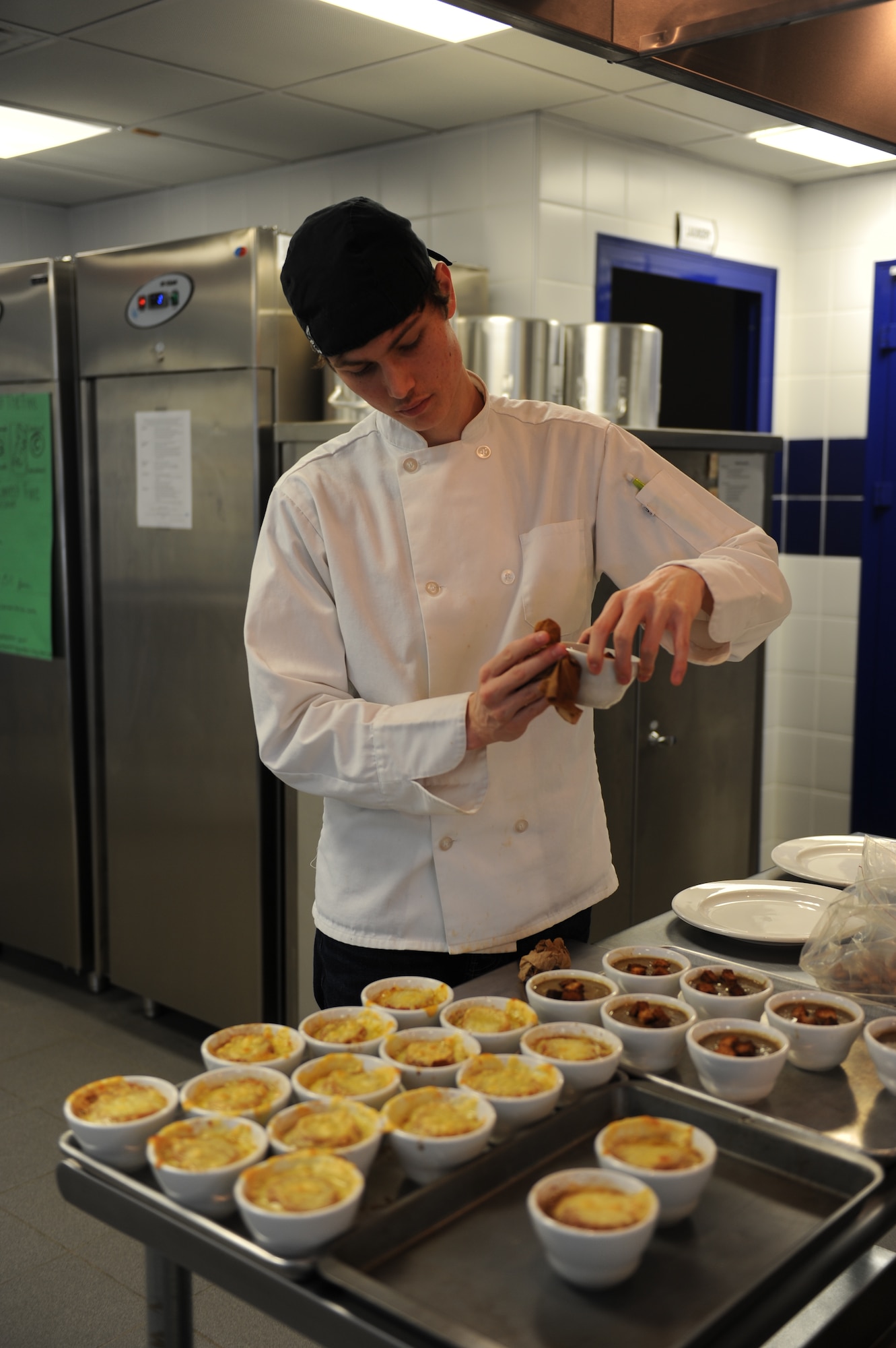 Jacen, a senior at Incirlik Unit school and Culinary Arts student, wipes a bowl of soup before serving during a lunch hosted by the Culinary Arts class for members of the 728th Air Mobility Squadron Feb. 6, 2015, at Incirlik Air Base, Turkey. The class often holds lunch for different units on base allowing the students to get a feel of how to interact with quests and to showcase what they have learned. (U.S. Air Force photos by Tech. Sgt. Taylor Worley)