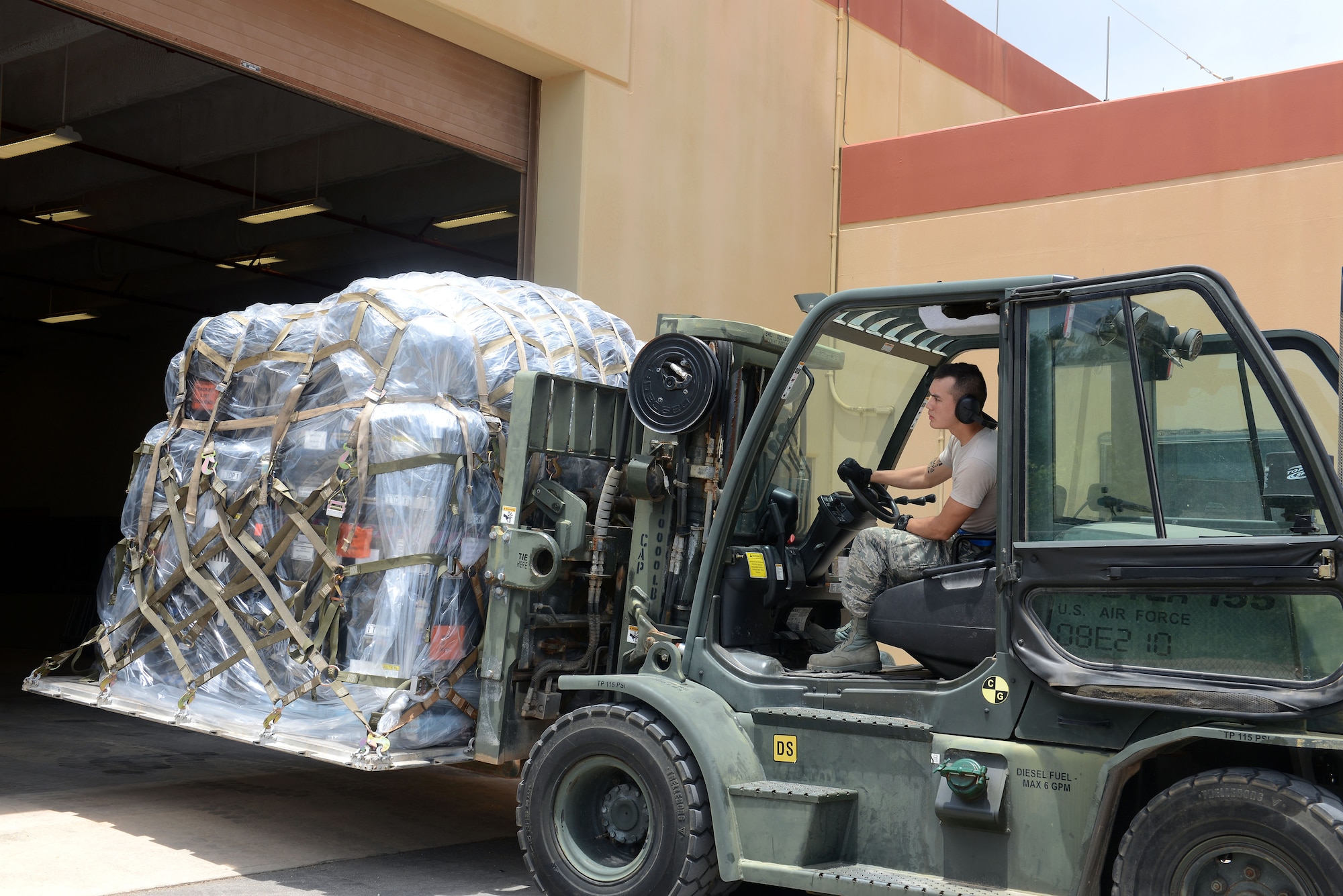Senior Airman Austin Jeanneret, 644th Combat Communications Squadron cyber systems technician, uses a forklift to position pallets which holds communications equipment May 12, 2015, at Northwest Field, Guam. The unit is tasked with providing communication for a site that can range anywhere from 50 to 3,000 members, depending on operational needs. (U.S. Air Force photo by Airman 1st Class Arielle Vasquez/Released)