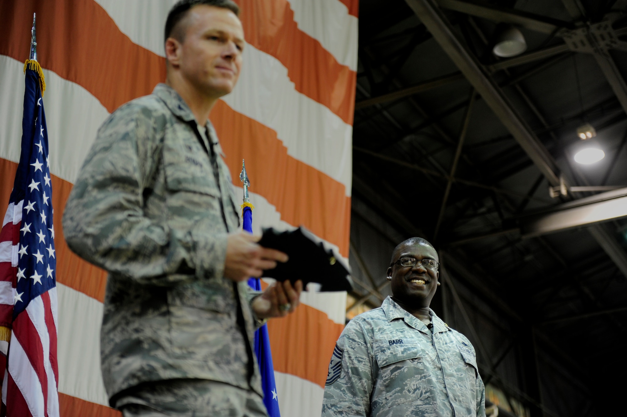 Col. Kenneth P. Ekman, 8th Fighter Wing commander, says a few words before presenting a gift to Chief Master Sgt. Lee Barr, 8th FW command chief, during Barr’s retirement ceremony at Kunsan Air Base, Republic of Korea, May 12, 2015. Barr spent 22 years in the security forces career field while supporting and deploying in Operations Desert Shield and Storm, Southern Watch, Noble Eagle, Iraqi Freedom and Odyssey Dawn. He will have served in the Air Force for 30 years when he retires in November. (U.S. Air Force photo by Senior Airman Taylor Curry/Released) 