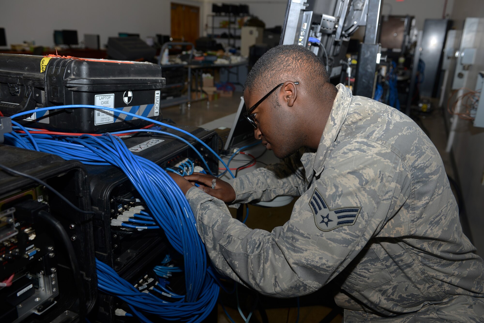Senior Airman Shameer Goss, 644th Combat Communications Squadron network administrator, logs into a deployable network server to ensure it is in working condition May 12, 2015, at Northwest Field, Guam. The unit is tasked with providing communication for a site that can range anywhere from 50 to 3,000 members, depending on operational needs. (U.S. Air Force photo by Airman 1st Class Arielle Vasquez/Released)