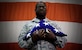 Chief Master Sgt. Lee Barr, 8th Fighter Wing command chief, holds an American flag folded by the 8th FW honor guard as part of his retirement ceremony at Kunsan Air Base, Republic of Korea, May 12, 2015. Barr spent 22 years in the security forces career field while supporting and deploying in Operations Desert Shield and Storm, Southern Watch, Noble Eagle, Iraqi Freedom and Odyssey Dawn. He will have served in the Air Force for 30 years when he retires in November. (U.S. Air Force photo by Senior Airman Taylor Curry/Released)