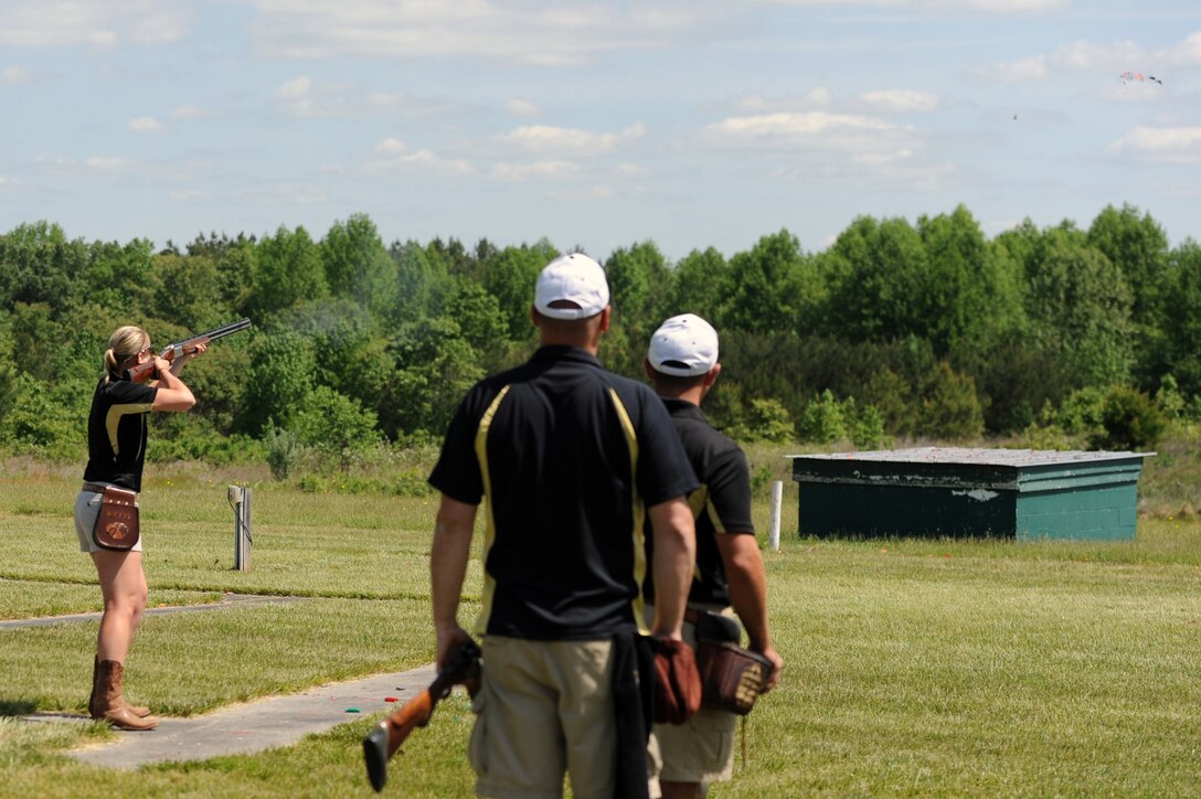 Army Skeet Team member Capt. Katie Fichtner destroys the clay pigeon target during the 55th Annual Armed Services Skeet Championships as her teammates look on. The five-day competition was held May 11-15, 2015, at Conservation Park in Charles City, Va. DoD photo by Marvin Lynchard