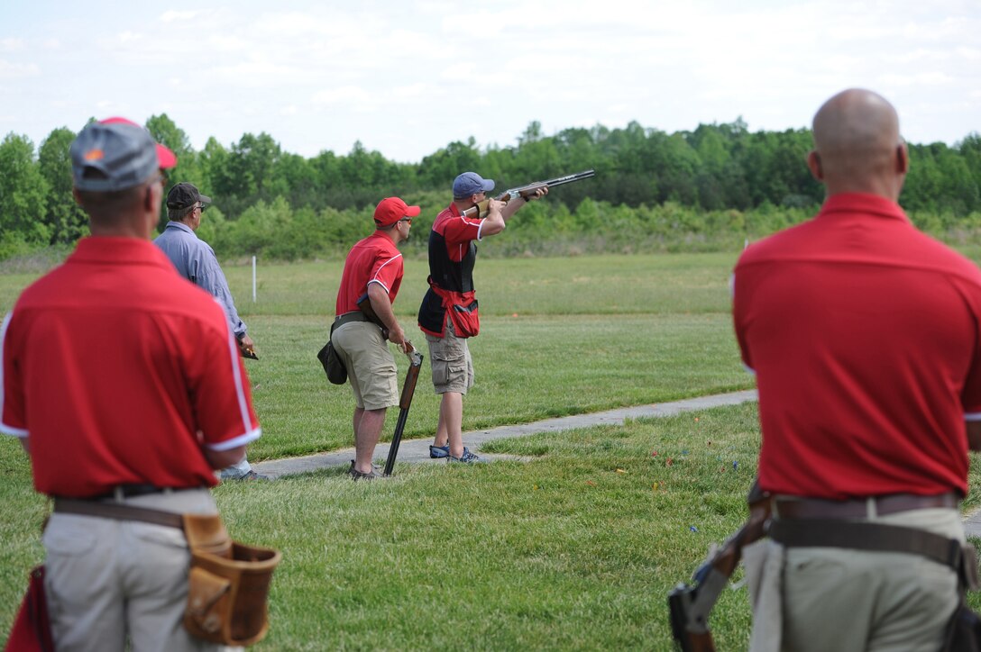 Marine Corps Skeet Team member 1st Lt. Patrick Fedak shoots as his teammates look on during the 55th Annual Armed Services Skeet Championships. The five-day competition was held May 11-15, 2015, at Conservation Park in Charles City, Va. DoD photo by Marvin Lynchard