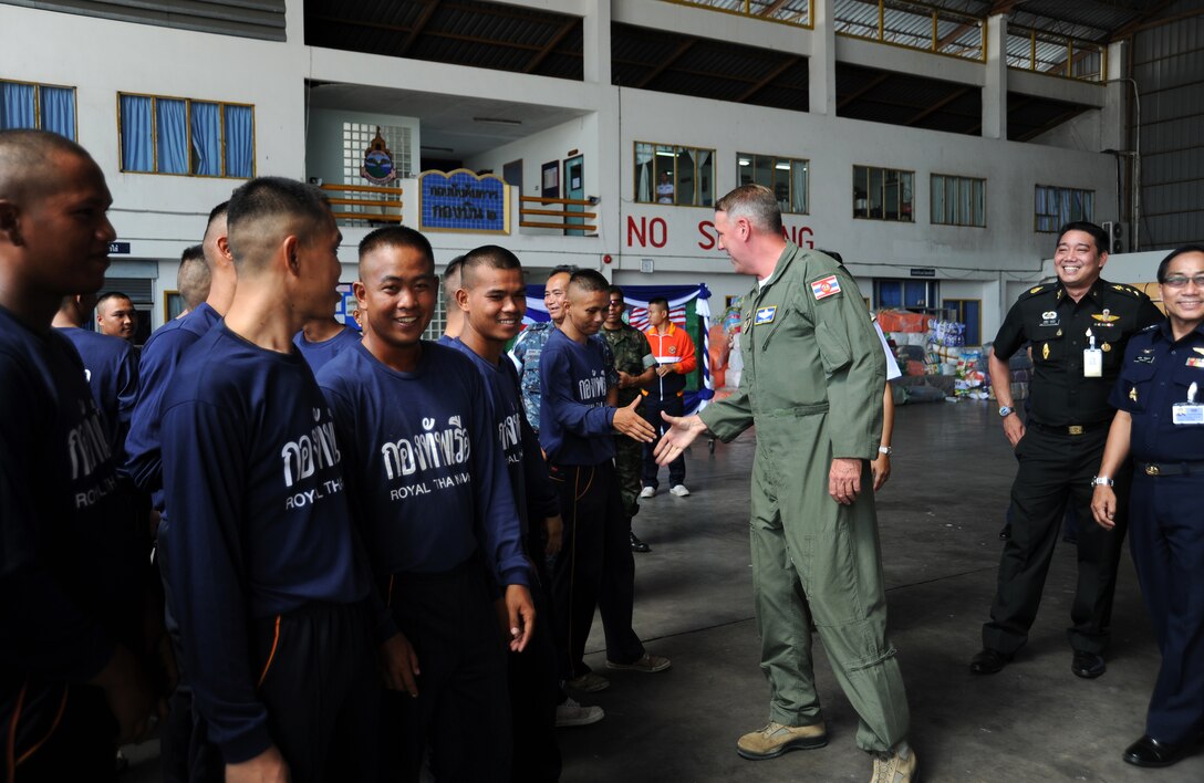 U.S. Air Force Brig. Gen. Michael Minihan, right, commander of Joint Task Force 505, shakes hands with a Royal Thai Navy seaman at U-Tapao Royal Thai Naval Airfield, Thailand, May 19, 2015.