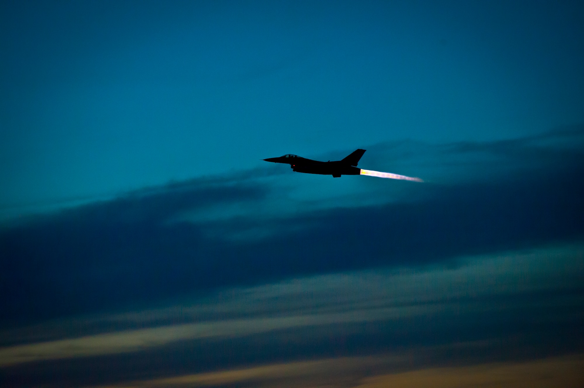 An F-16 Fighting Falcon takes off at Holloman Air Force Base, N.M. May 13, 2015. The 311th Fighter Squadron, a tenant unit from Luke Air Force Base, Ariz., trains F-16 pilots at Holloman. The students are currently at a point in their syllabus where they are learning how to use night vision goggles and perform combat night operations.  (U.S. Air Force photo by Airman 1st Class Emily A. Kenney/Released)
