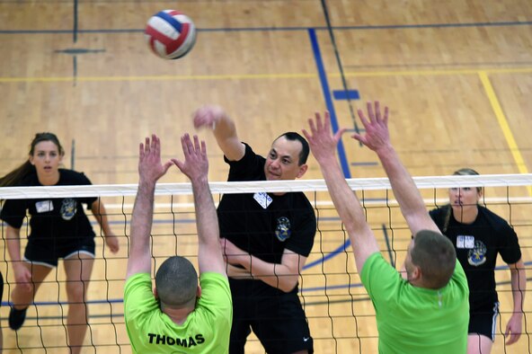 Volleyball players compete against each other for 1st place during the Tri-Wing Sports Day competition May 20, 2015, on Buckley Air Force Base, Colo. Tri-Wing Sports Day is held once a year between the three Air Force Space Command bases and is intended to promote healthy, active lifestyles and friendly competition. The bases competed against each other in over 15 sports such as volleyball, football, tennis and softball among others. (U.S. Air Force photo by Airman 1st Class Emily E. Amyotte/Released)