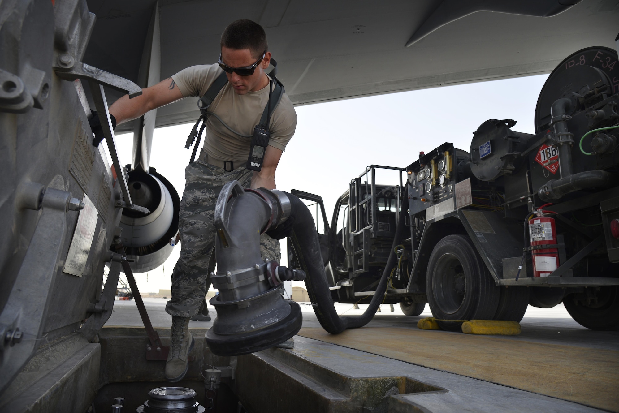Airman 1st Class Arnaldo connects an R-12 refueling vehicle nozzle to a hydrant system to refuel a KC-10 Extender at an undisclosed location in Southwest Asia May 18, 2015. The R-12 refueling vehicle draws fuel from an underground hydrant system and pushes it to aircraft. Airman Arnaldo is a fuels distribution operator assigned to the Expeditionary Logistics Readiness Squadron. Due to safety and security reasons, last names and unit designators were removed. (U.S. Air Force photo/Tech. Sgt. Christopher Boitz) 