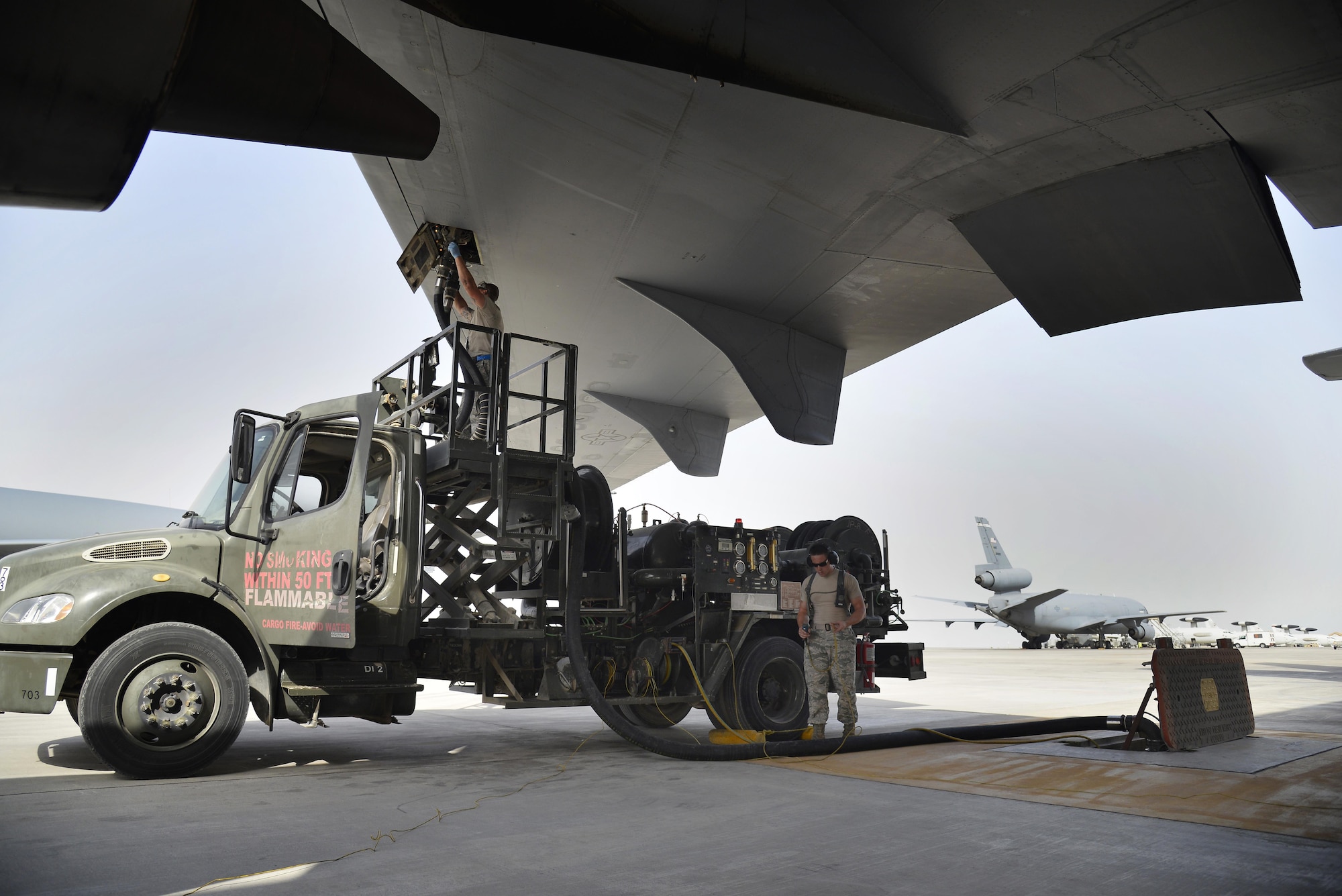 Airman 1st Class Arnaldo refuels a KC-10 Extender with an R-12 refueling vehicle at an undisclosed location in Southwest Asia May 18, 2015. Airman Arnaldo is a fuels distribution operator assigned to the Expeditionary Logistics Readiness Squadron. Due to safety and security reasons, last names and unit designators were removed. (U.S. Air Force photo/Tech. Sgt. Christopher Boitz) 