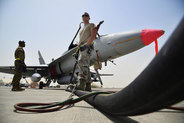 Airman 1st Class Jake refuels a Royal Australian Air Force F/A-18 at an undisclosed location in Southwest Asia May 18, 2015. Airman Jake is a fuels distribution operator assigned to the Expeditionary Logistics Readiness Squadron. Due to safety and security reasons, last names and unit designators were removed. (U.S. Air Force photo/Tech. Sgt. Christopher Boitz) 