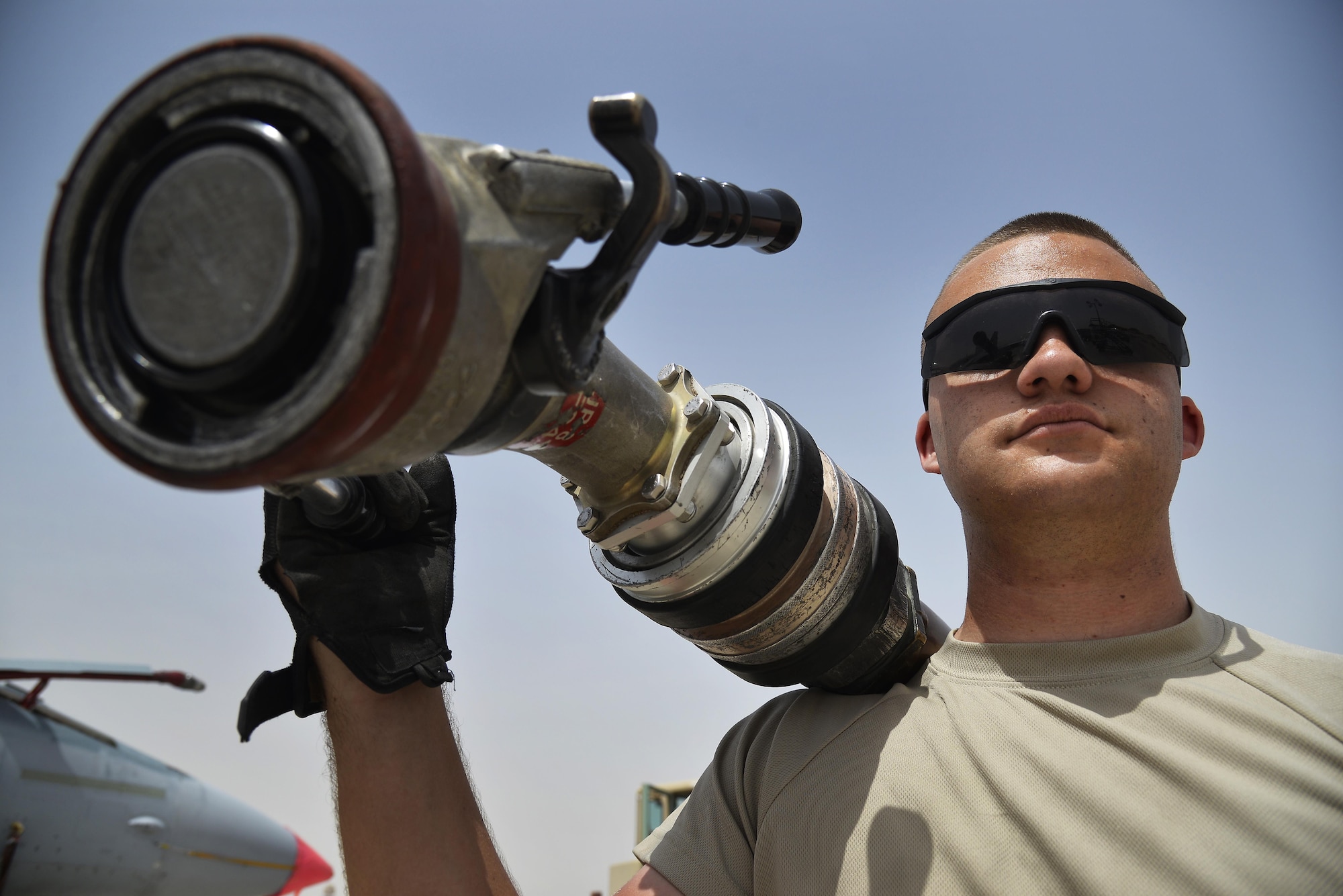 Airman 1st Class Jake holds an R-11 refueling vehicle nozzle at an undisclosed location in Southwest Asia May 18, 2015. Airman Jake is a fuels distribution operator assigned to the Expeditionary Logistics Readiness Squadron. Due to safety and security reasons, last names and unit designators were removed. (U.S. Air Force photo/Tech. Sgt. Christopher Boitz) 