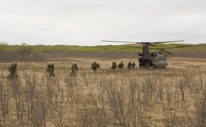 A CH-147F Chinook with 450 Tactical Helicopter Squadron, Royal Canadian Air Force, prepares to transport Soldiers from the Canadian Army during Exercise Maple Resolve 2015 aboard Canadian Manoeuvre Training Center, Camp Wainwright, Alberta, Canada, May 16, 2015. The multi-national exercise, conducted annually by the Canadian Army, is a three-week, high-readiness validation exercise for Canadian Army elements designated for domestic or international operations. This year, the 1st Canadian Army Division and the 5th Canadian Mechanized Battle Group (5 CMBG) are being supported by the British 12th Armoured Infantry Brigade, various U.S. Army elements, and for the first time, members of  I MEF’s 1st ANGLICO who bring a unique capability to the table. (Photo by Cpl. Owen Kimbrel, U.S. Marine Corps)