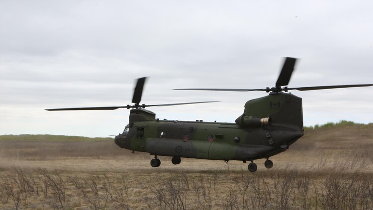 A CH-147F Chinook with the 450 Tactical Helicopter Squadron, Royal Canadian Air Force, takes off while transporting Soldiers from the Canadian Army during Exercise Maple Resolve 2015 aboard Canadian Manoeuvre Training Center, Camp Wainwright, Alberta, Canada, May 16, 2015. The multi-national exercise, conducted annually by the Canadian Army, is a three-week, high-readiness validation exercise for Canadian Army elements designated for domestic or international operations. (Photo by Cpl. Owen Kimbrel, U.S. Marine Corps)