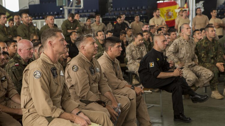 Service members from multiple nations attend a pre-flight brief during Exercise Lone Paratrooper at Leόn Air Base, Spain, May 18, 2015. The multinational exercise integrated paratroopers from different countries to simultaneously conduct High Altitude Low Opening and High Altitude High Opening jumps.