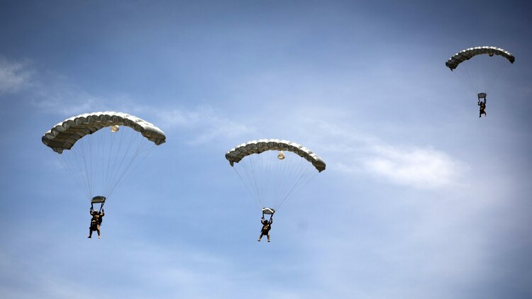Paratroopers from multiple nations glide to the landing zone after jumping out of a KC-130J from Special-Purpose Marine Air-Ground Task Force Crisis Response-Africa during Exercise Lone Paratrooper at León Air Base, Spain, May 18, 2015. The exercise integrated paratroopers from different countries to simultaneously conduct High Altitude Low Opening and High Altitude High Opening jumps.