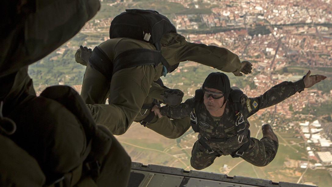 A Brazilian paratrooper looks back after jumping out of a KC-130J from Special-Purpose Marine Air-Ground Task Force Crisis Response-Africa during Exercise Lone Paratrooper at Leόn Air Base, Spain, May 18, 2015. The multinational exercise integrated various paratroopers from different countries to simultaneously conduct High Altitude Low Opening and High Altitude High Opening jumps.