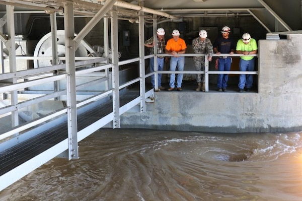 Col. Richard A. Pratt, U.S. Army Corps of Engineers, Tulsa District, commander (center), Mike Abate, with the District's Civil Works Branch (far left) and members of the Eufaula Lake Dam operations and maintenance team, obverse water spiraling down through one of the dam's Tainter gates, as the amount of water being released through the gates was increased from 48,000 to 62,000 cubic feet per second, May 18, 2015.