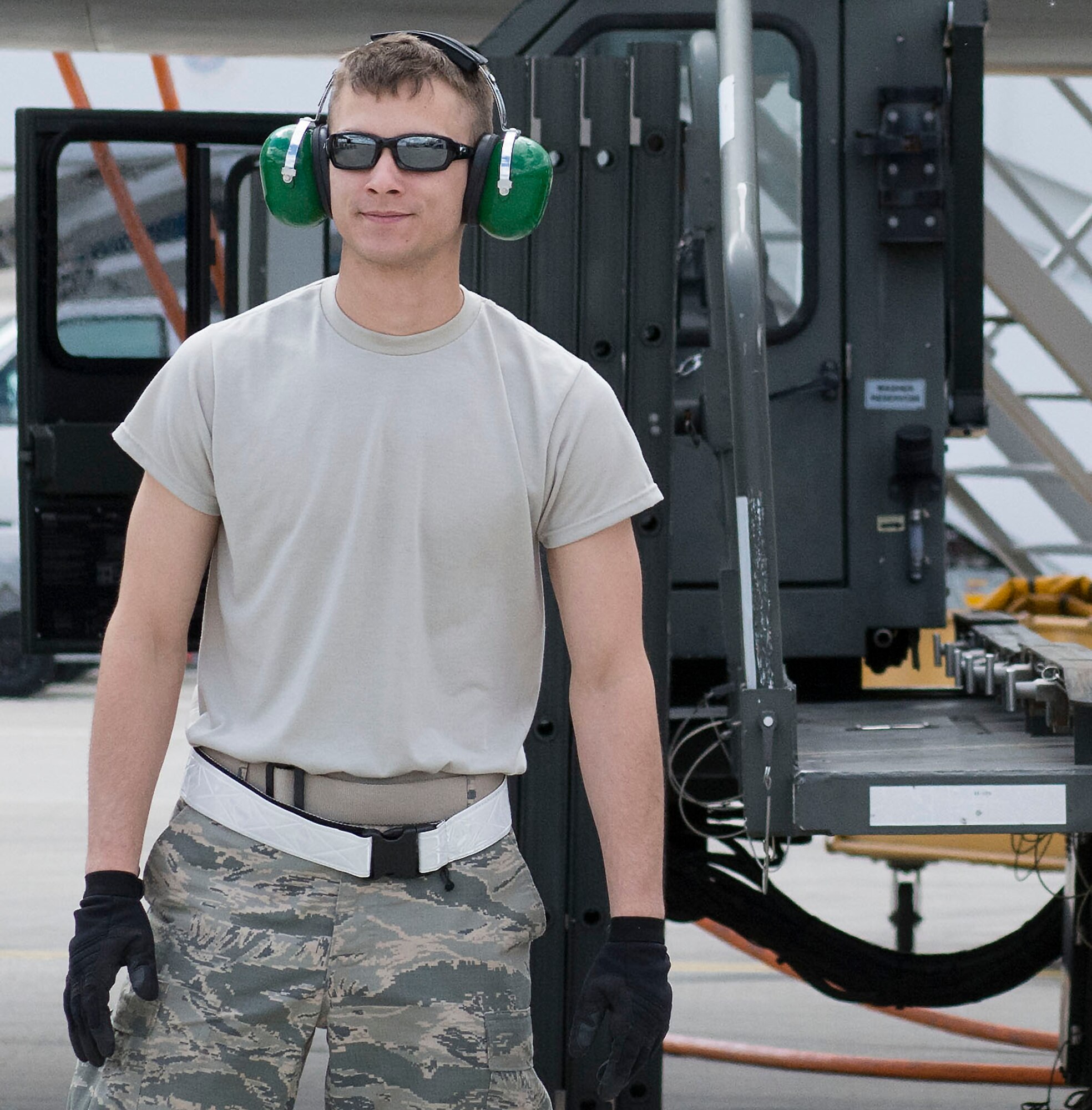 Airman 1st Class Patrick J. Lokhaiser, an air transportation specialist with the 32nd Aerial Port Squadron from Pittsburgh, waits to unload a luggage pod on the flight line at Ramstein Air Base, Germany, May 6, 2015. (U.S. Air Force photo by Staff Sgt. Brandy Grace)