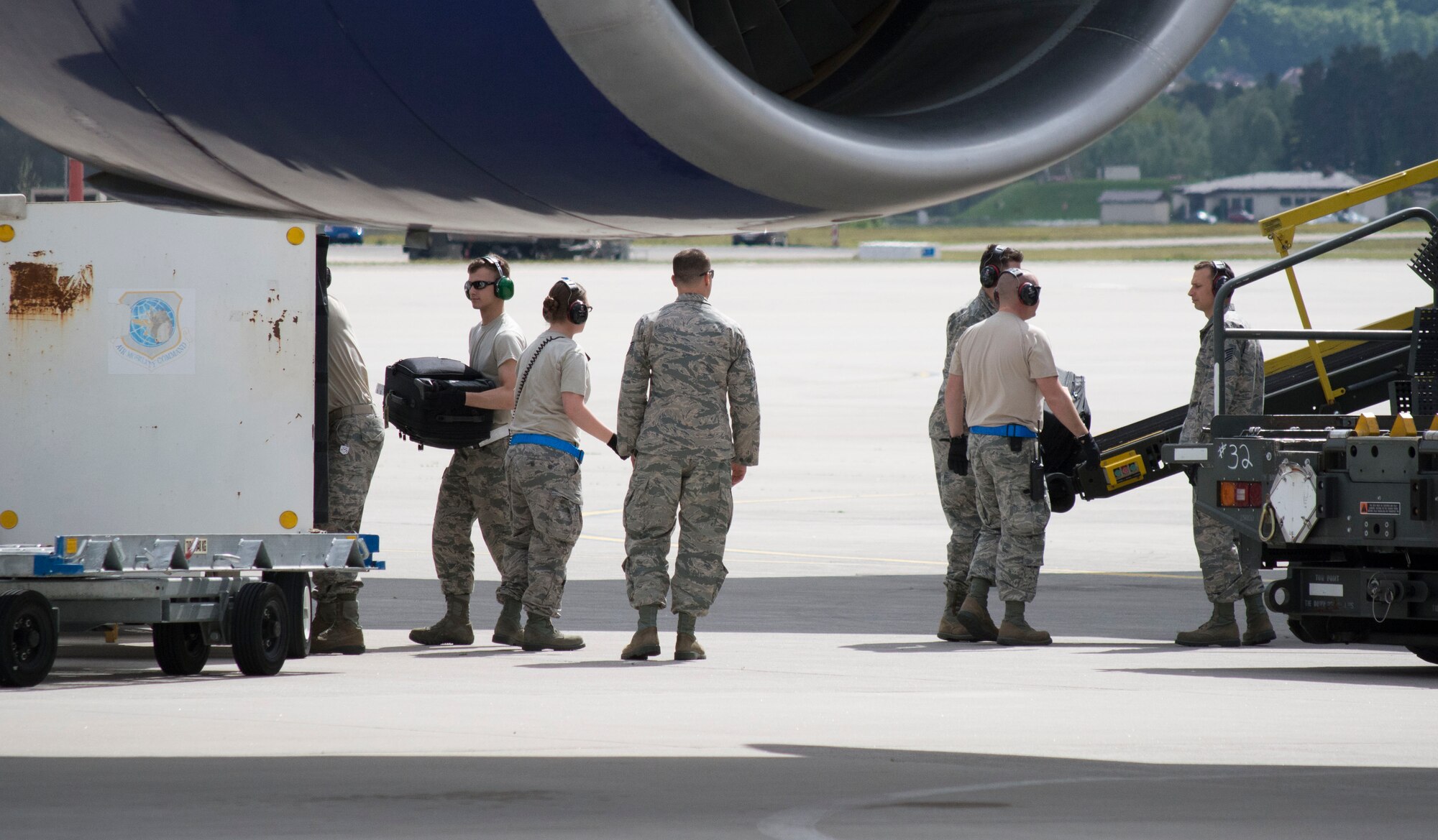 Airman 1st Class Patrick J. Lokhaiser (left), an air transportation specialist with 32nd Aerial Port Squadron, and his active-duty counterparts from the 721st APS, unload passenger luggage from a Boeing 747on the flight line at Ramstein Air Base, Germany, May 6, 2015. Careful handling of passenger luggage ensures travelers receive their belongings in the same condition as when they were packed. (U.S. Air Force photo by Staff Sgt. Brandy Grace)