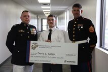 Capt. Matthew A. Lamb, Executive Officer of Recruiting Station Indianapolis presents the Naval Reserve Officer Training Corps Scholarship to Derric L. Salser. Scholarship selection is based on  commitments to the classroom, community and physical fitness. 