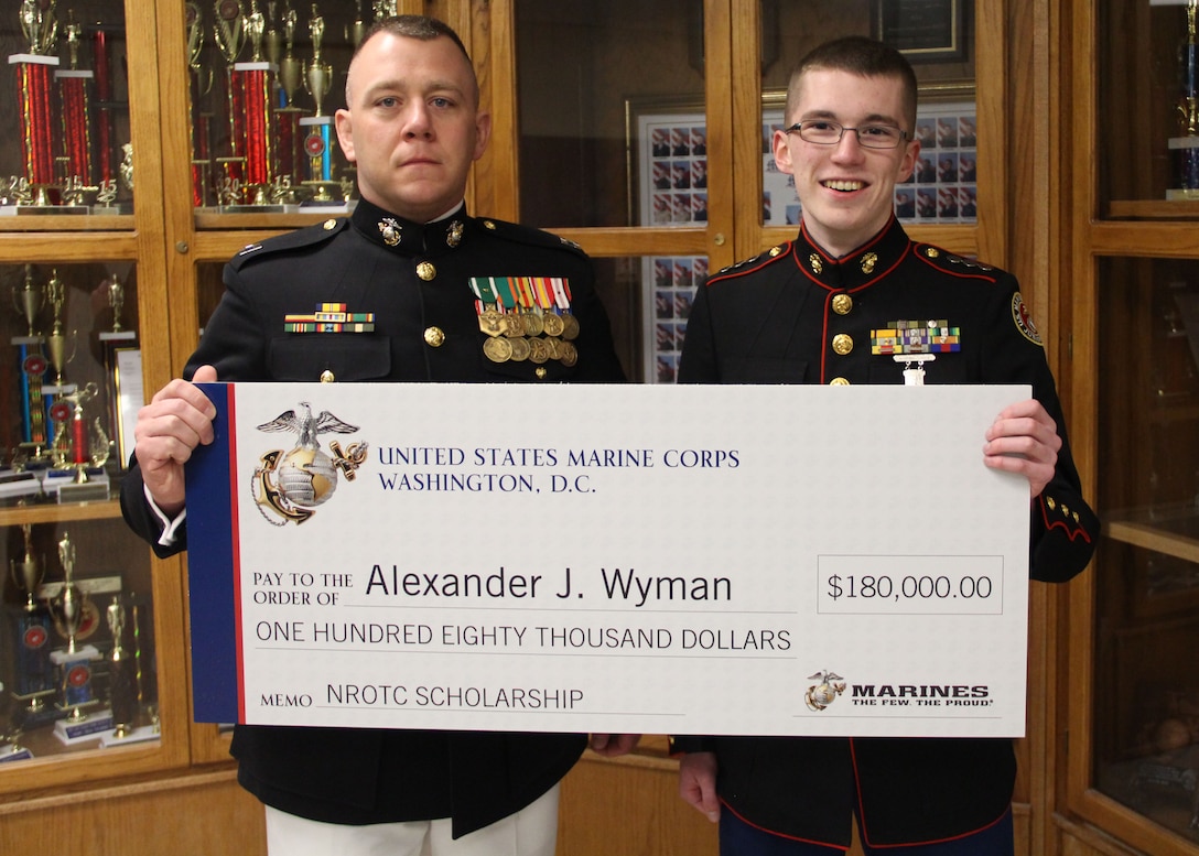 Capt. Matthew A. Lamb, Executive Officer of Recruiting Station Indianapolis presents the Naval Reserve Officer Training Corps Scholarship to Alexander J. Wyman. Scholarship selection is based on  commitments to the classroom, community and physical fitness.