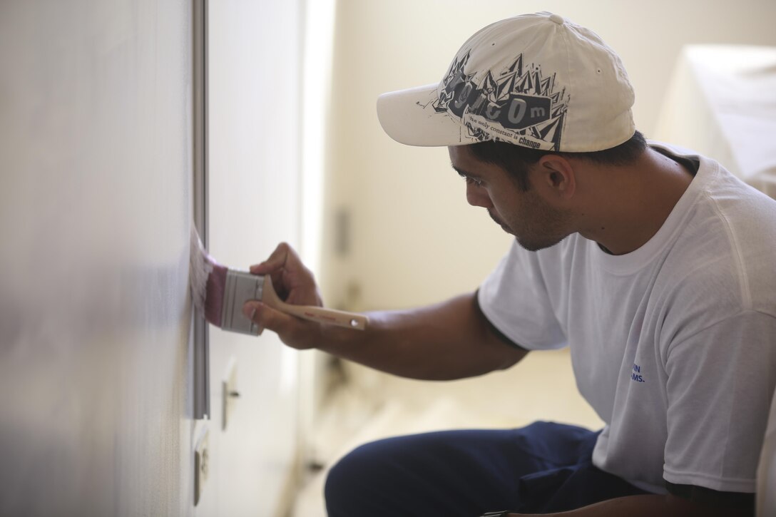 Brock Pulliam, a Waiahole, Hawaii, native, paints one of the rooms in the Wounded Warrior Battalion West-Detachment Hawaii, May 16, 2015, aboard Marine Corps Base Hawaii. The volunteers dedicated a portion of their weekend in honor of National Painting Week, a time spent focusing on giving back to the community and supporting community development. (U.S. Marine Corps photo by Lance Cpl. Harley Thomas/Released)