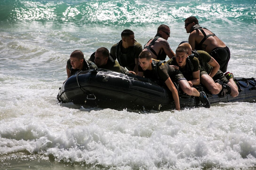 U.S. Marines with the 15th Marine Expeditionary Unit’s Maritime Raid Force ride a combat rubber raiding craft ashore aboard Bellows Air Force Station, Hawaii, May 15, 2015. The 15th MEU’s Force Reconnaissance Detachment helped familiarize the security element Marines with surf passage, broaching and casting procedures. (U.S. Marine Corps photo by Cpl. Anna Albrecht/Released)
