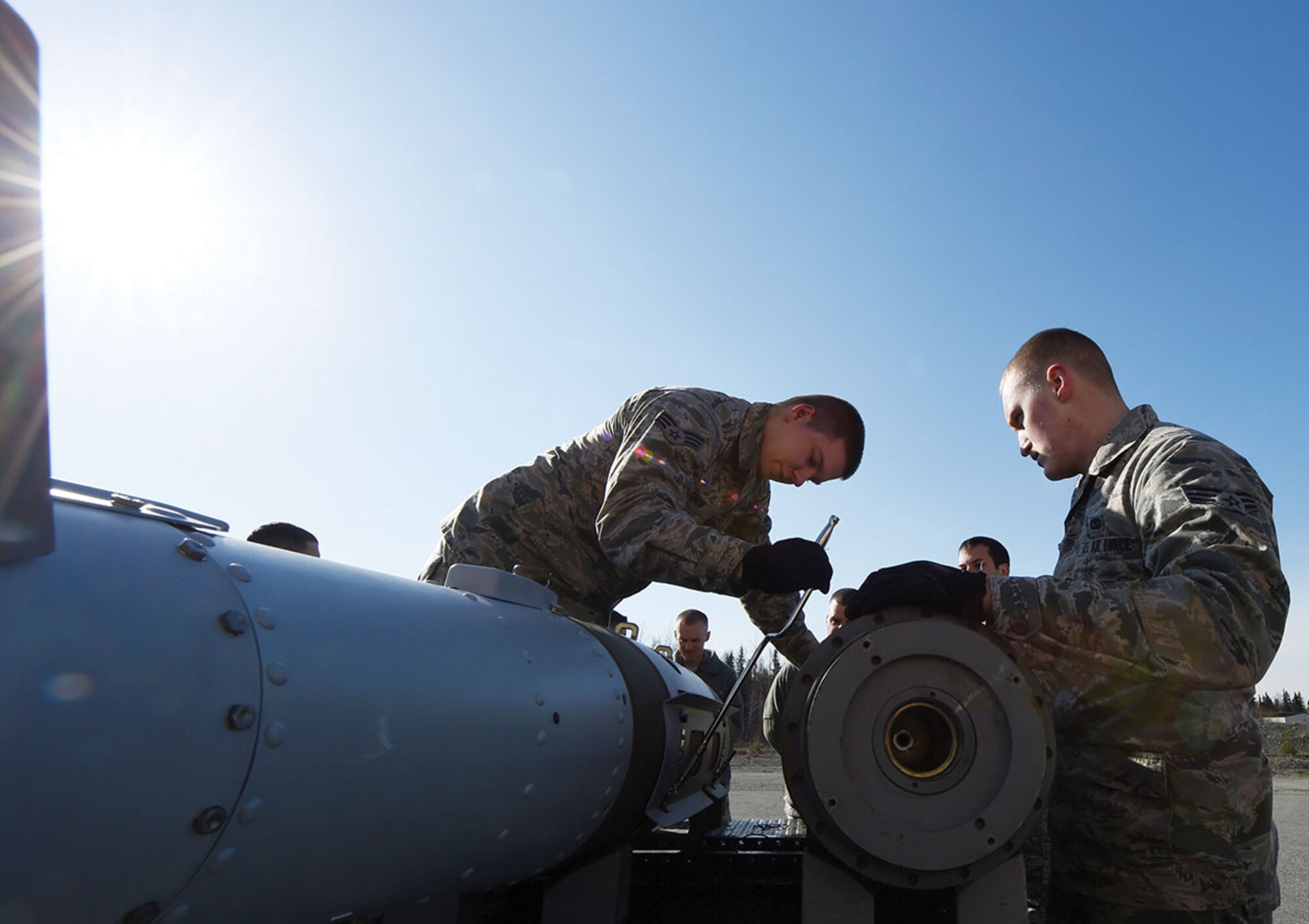 Senior Airmen Michael Crow (left) and Evan Kirchner, both assigned to the 3rd Munitions
Squadron, attach strakes to a GBU-32 Joint Direct Attack Munition during combat munitions training at Joint Base Elmendorf-Richardson April 23. (U.S. Air Force photo/Staff Sgt. Sheila deVera)