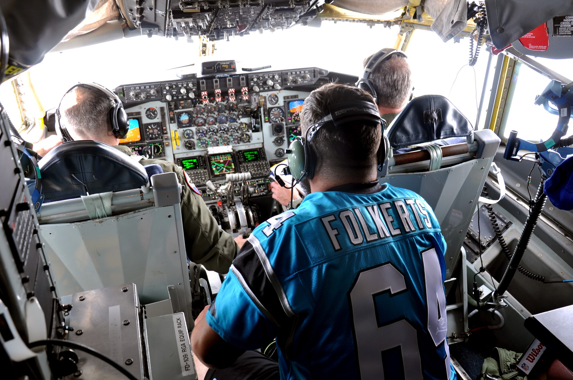 Brian Folkerts, Carolina Panthers center, sits behind the cockpit of a KC-135R Stratotanker during a 916th Air Refueling Wing flight, May 15, 2015. Members of the Panthers organization flew and observed 916th Airmen operate as part of the Wings Over Wayne Airshow kick-off festivities. (USAF photo by Senior Airman Jeramy Moore, 916ARW/PA)