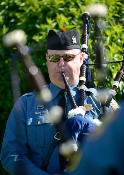 Capt. Daniel K. Meadows, Delaware State Police criminal intelligence director, plays the bagpipes while facing another piper during the formal retreat ceremony marking the end of Police Week May 15, 2015, at Dover Air Force Base, Del. The ceremony which was attended by representatives from local and regional law enforcement agencies. (U.S. Air Force photo/Greg L. Davis)