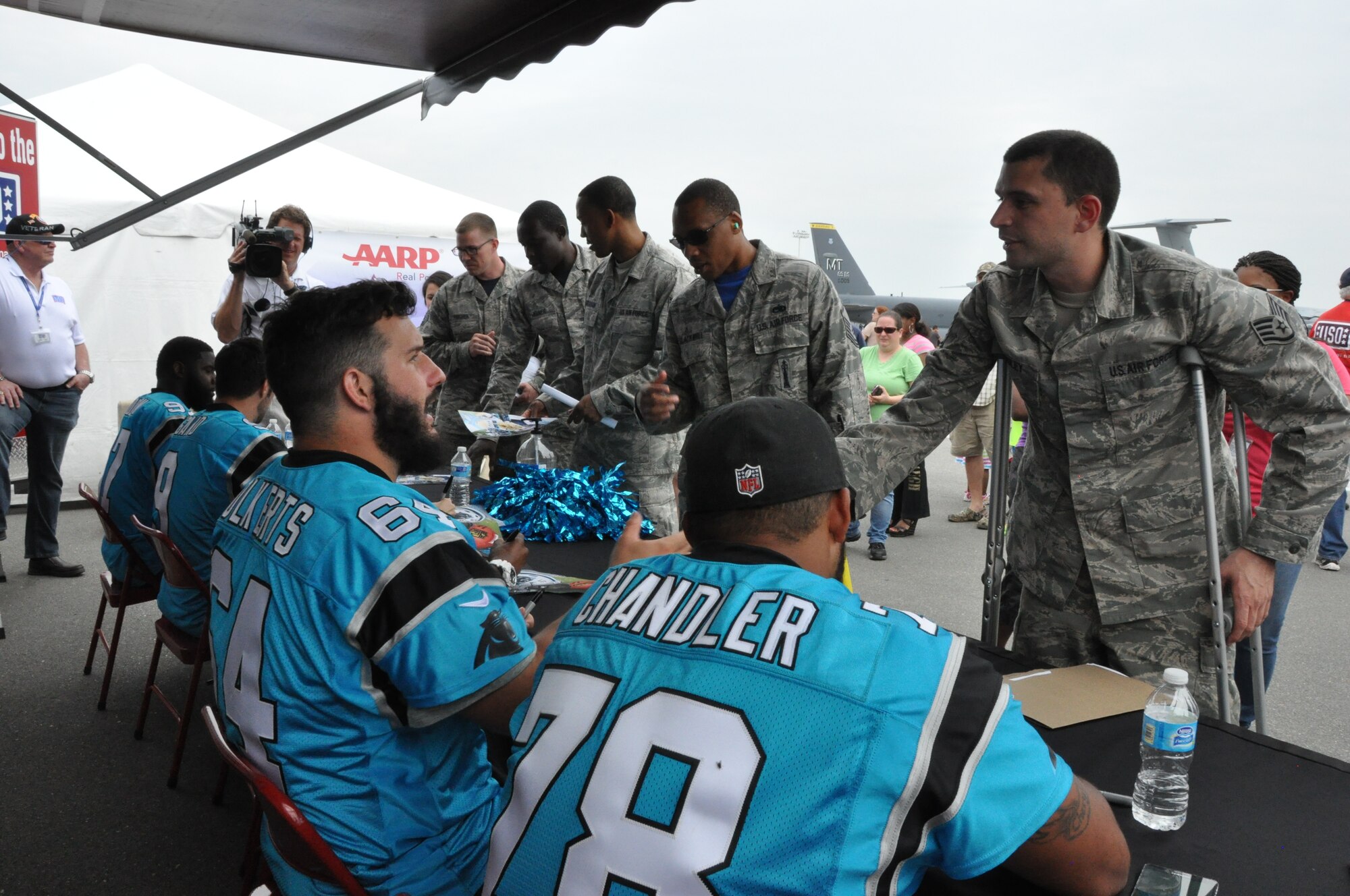 Staff Sgt. Jeffrey Lindley, 916th Air Refueling Wing, greets Brian Folkerts, Carolina Panthers center at Seymour Johnson Air Force Base, North Carolina, May 15, 2015. Members of the Panthers organization toured base facilities, signed autographs and met with fans as part of the Wings Over Wayne Airshow kick-off festivities. (USAF photo by Master Sgt. Wendy Lopedote, 916ARW/PA)
